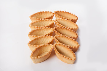 Sand tartlets oval on a white background. Lots of forms to fill out. The view from the top. An isolated object. background.