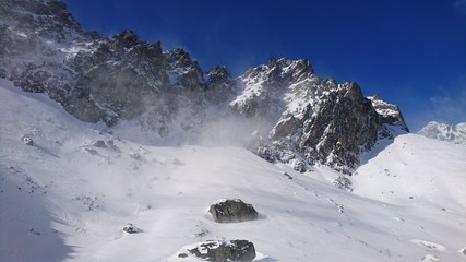 Blizzard snow storm in the High Tatra mountains cloud ice fog mist blowing wind sunny deep blue