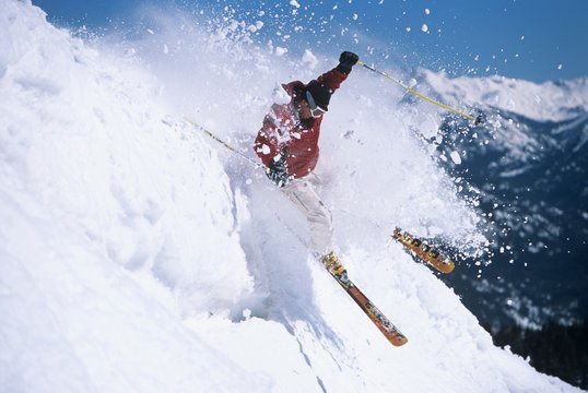 Skier Through Powdery Snow On Ski Slope