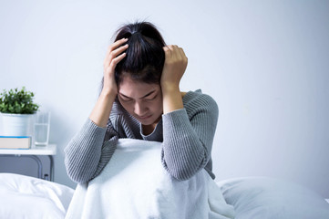 Sick woman with headache and  feel sick on bed