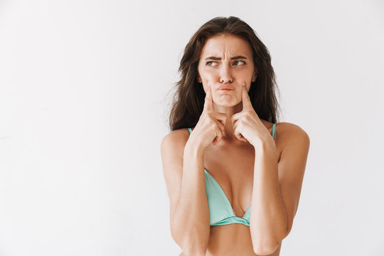 Beautiful young slim girl wearing bikini standing isolated