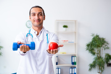 Young male doctor in sport and dieting concept