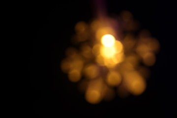 Abstract beautiful golden blur bokeh look like star and flower flare lights background for Christmas and New Year holidays