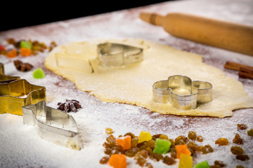 dough on table with cutters amd dried fruits