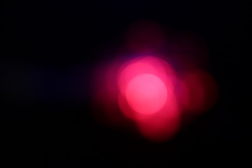 Christmas blurred pink red light snowflake bokeh with black background