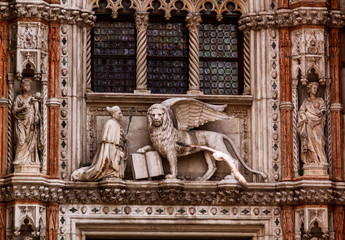 Venetian lion and Saint Mark on the pediment of the Doge's Palace. Venice, Italy.