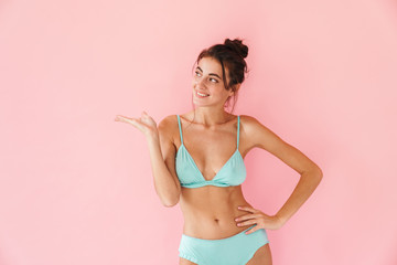 Beautiful young slim girl wearing bikini standing isolated