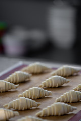 Raw croissants preparation for with raw egg painted on top process before baking /baking concept / copy space