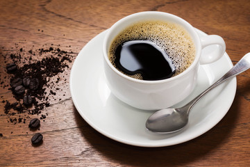 Beautiful coffee mugs on a white plate and coffee on the wood floor looks delicious.