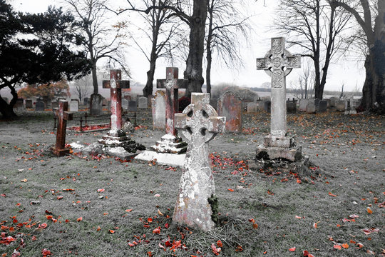 scarey grave yard with crosses as head stones back and white photograph