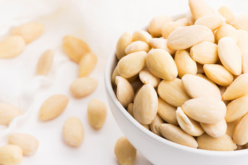 Bowl of almonds on a white background