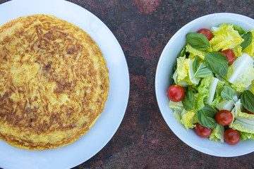 Traditional Spanish potatoes tortilla omelette with salad on a rusty table delicious food tapa tapas eat eating  healthy