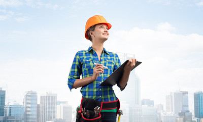 Young building inspector checking outdoor