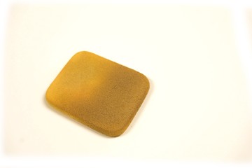 Close up of cosmetic sponge and stain on white background .