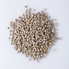 white peppercorns seed on white acrylic background