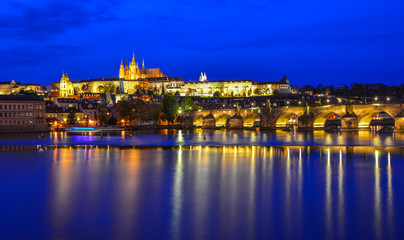 Fototapeta na wymiar Prague skyline and bridge over river in night