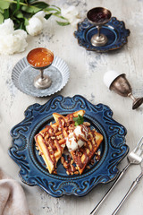 Viennese waffles on a blue plate. The concept of a hearty Breakfast. The view from the top.