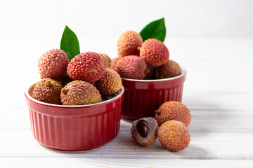 Ripe tropical lychee fruits on the table close up. Fresh and healthy food concept.