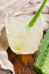Glassware with fresh aloe vera juice and leaves