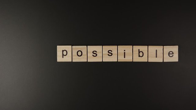 CONCEPT: Impossible to Possible - Human hand takes out a few letters