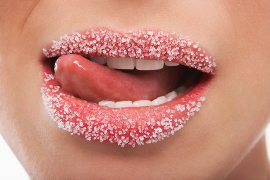 Woman Licking Lips Covered With Sugar