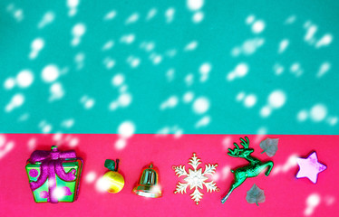Christmas present,reindeer snowflake fruits and bell on Red green background with snow fall and copy space,top  view