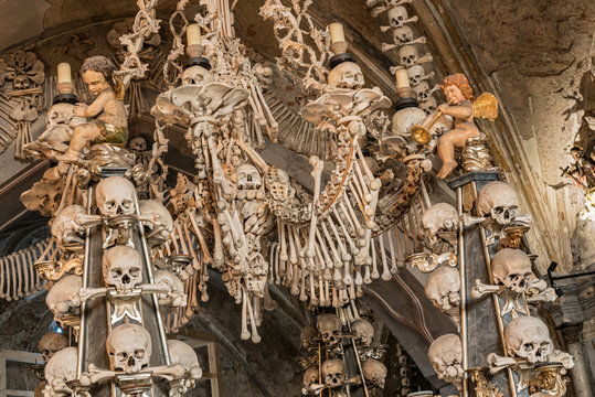 Prague, Czech Republic - Sept 04, 2019: Arranged Human Skulls and Bones in Kostnice Church in Kutna Hora, Czech Republic. Ossuary decoration of human bones and skulls