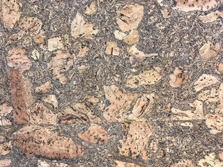 Decorative cork panel for facing cladding. Wooden brown background.