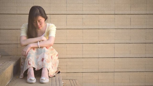 Slow motion,Asian woman sitting alone and depressed,stop abusing domestic violence, health anxiety.