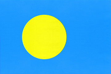 Republic of Palau national fabric flag, textile background. Symbol of world oceania country