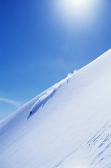 Skier Skiing On Mountain Slope