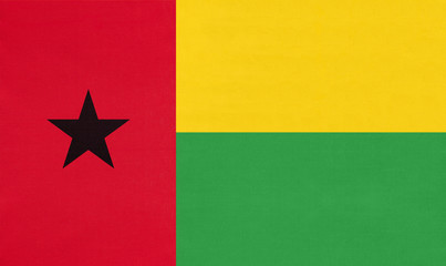 Republic of Guinea Bissau national fabric flag, textile background.