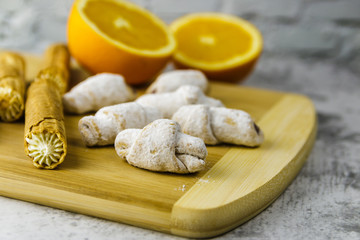 homemade confection and orange on wooden board