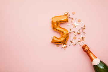 Happy 5th anniversary party. Champagne bottle with gold number balloon. - obrazy, fototapety, plakaty