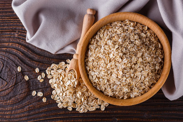 raw oatmeal on a wooden rustic background