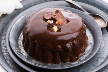 Chocolate pudding with chocolate dressing on a plate