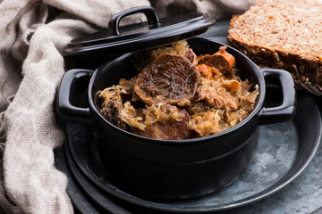 Traditional polish sauerkraut (bigos) with mushrooms and plums for christmas