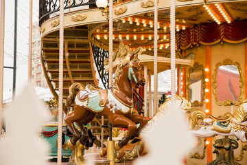 merry go round carousel with brown horse closeup