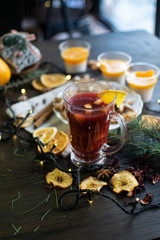 Mulled wine with christmas decorations and sweets close up