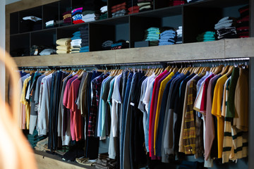 Assorted casual men clothes on shelves