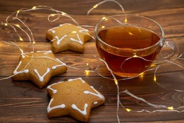 Cup of tea with gingerbread cookie in the form of stars