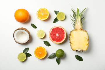 Flat lay with exotic fruits on white background, top view
