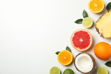 Flat lay with exotic fruits on white background, space for text