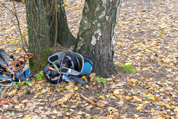 Left at tree climbing equipment. climbing straps with safety ropes, aluminum carabiners, loops and braces on the bench. End of climb