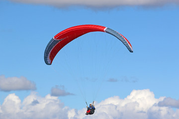 Paraglider flying wing in a blue sky	