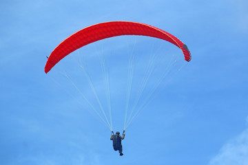 Paraglider flying wing in a blue sky	