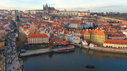 Aerial view of Charles Bridge and Prague Castle at sunset light in desember in Prague, Czech Republic