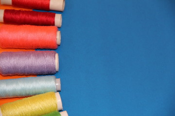 Spools of thread on a blue background