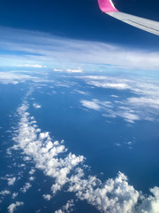 Fototapeta na wymiar Photos of clouds, blue sea and blue sky from an airplane.