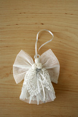 Light angel on wooden background. Space for text